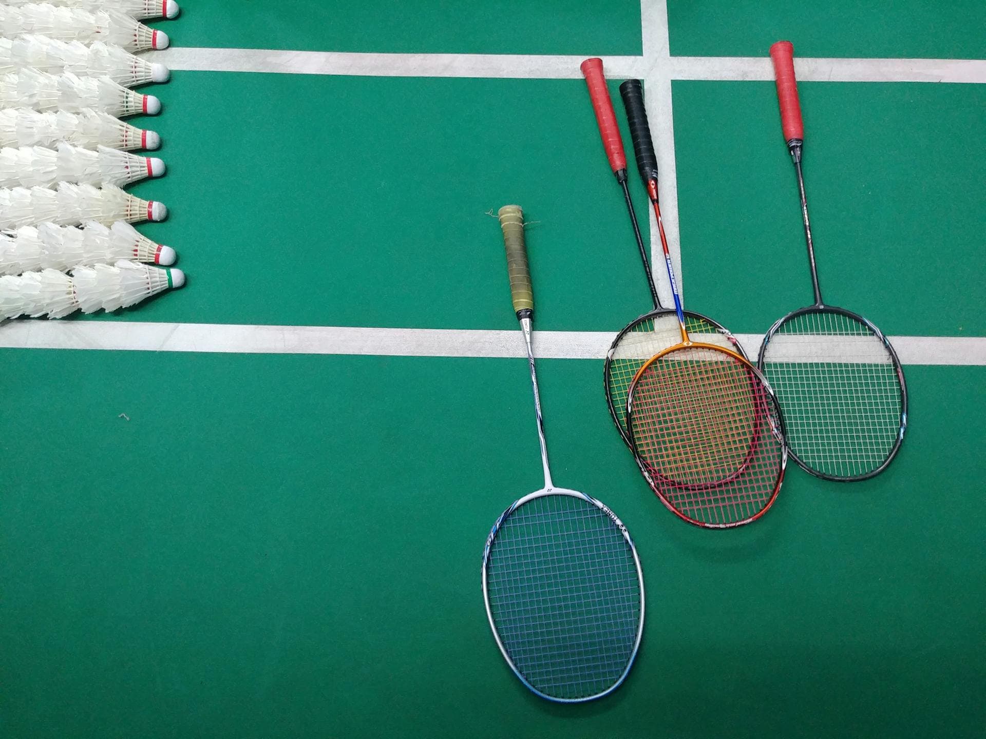 Badminton rackets and shuttlecocks on court